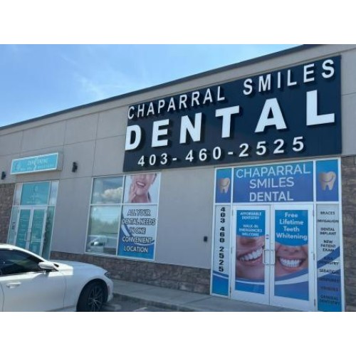 Exterior of Chaparral Smiles Dental clinic with a large DENTAL sign and promotional posters in the windows
