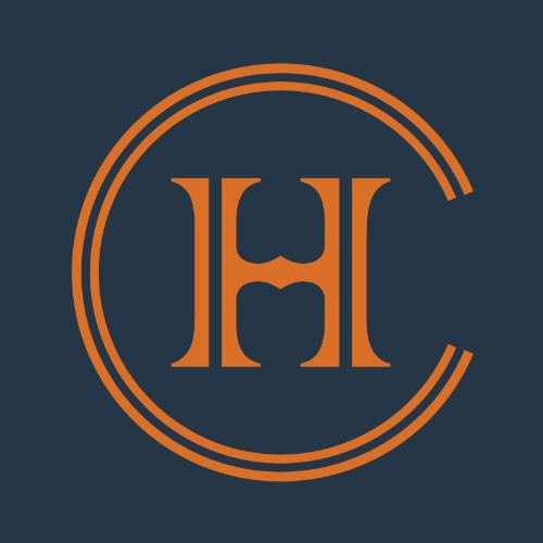 Orange monogram 'H' enclosed by a double circular ring on a dark navy background, forming a logo.